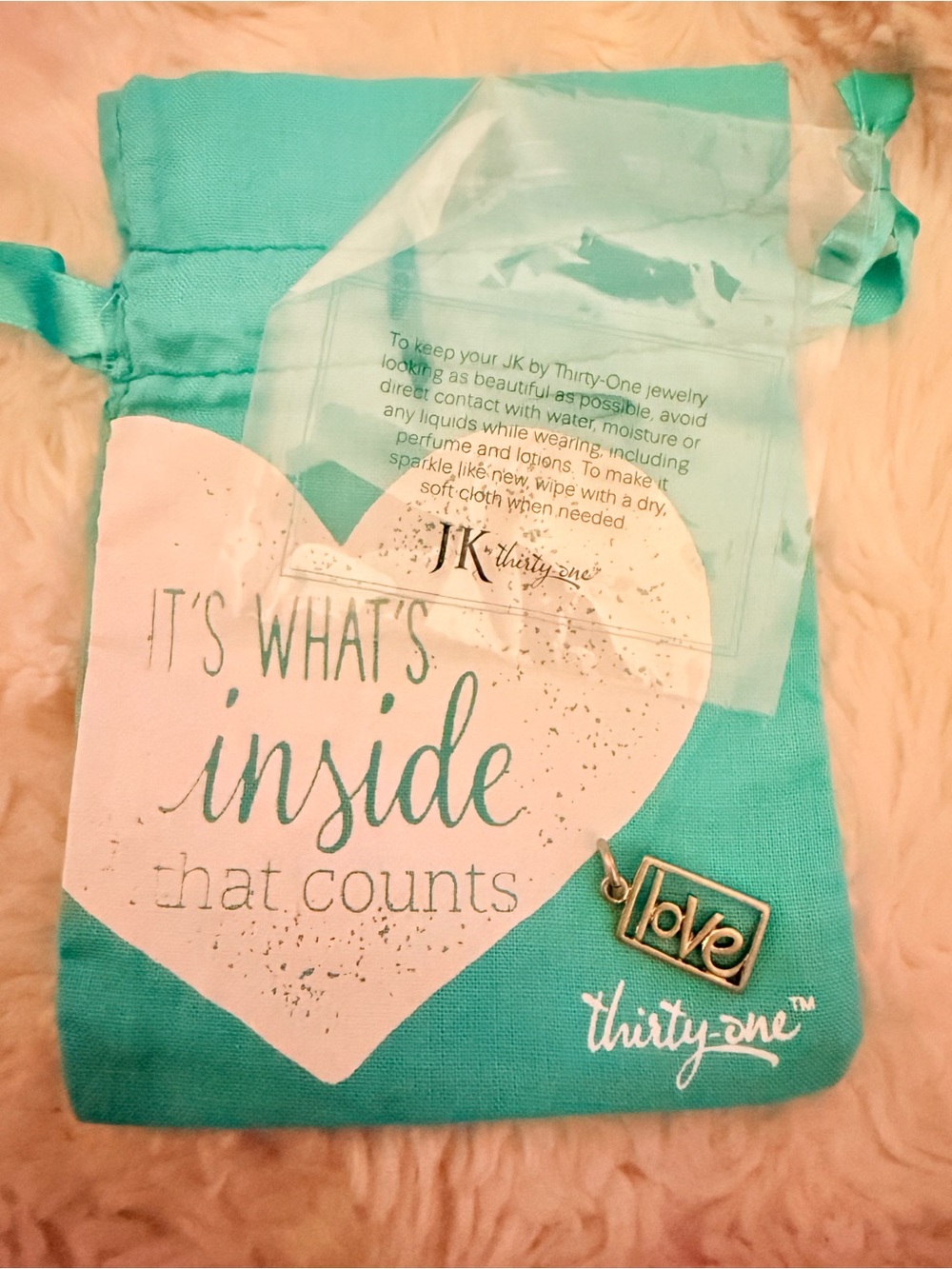 thirty-one silver 'love' charm